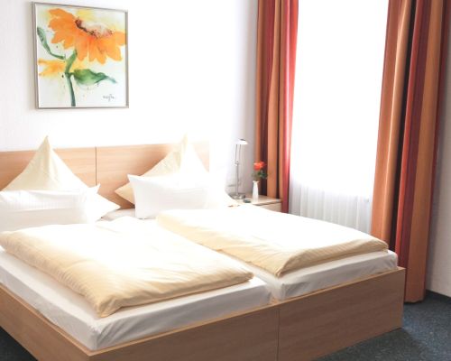 Bright sleeping area with a comfortable double bed and a homely design.