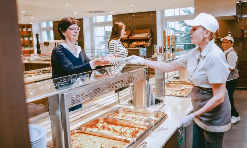 Hotel staff preparing food at the buffet counter