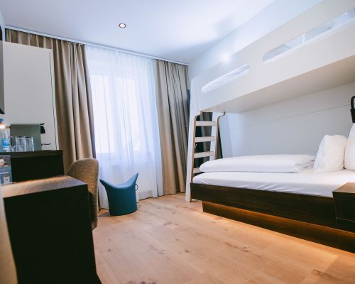 Welcoming room with warm wood details, a comfortable double bed and additional space
