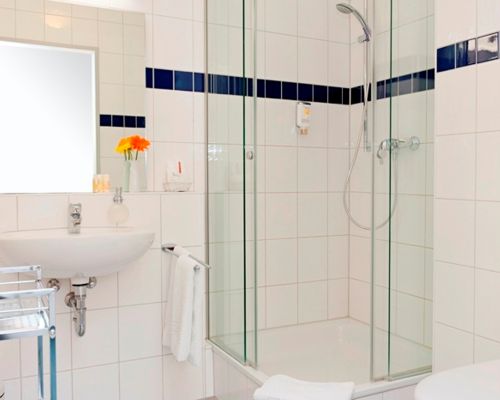 Bright bathroom with practical amenities and a comfortable shower.