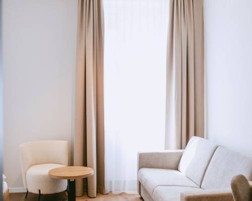 Welcoming room with warm wood details, a comfortable double bed and additional space
