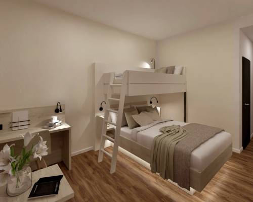 Room view with a desk, bunk bed, and double bed in the triple room